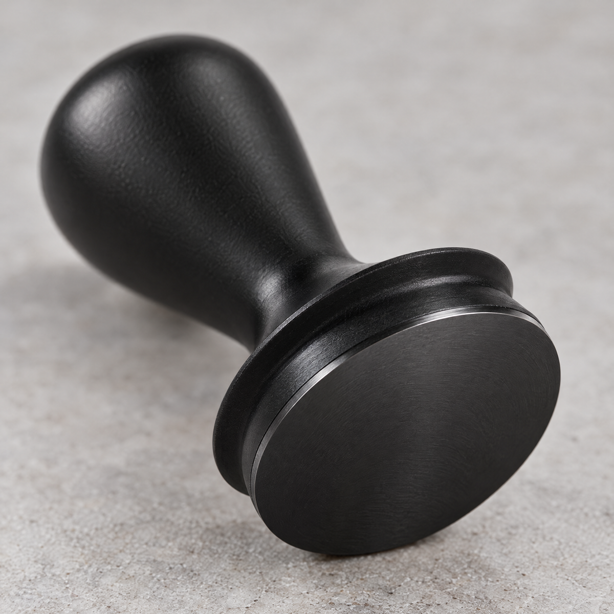 Close-up of the precision-machined flat base of the espresso tamper