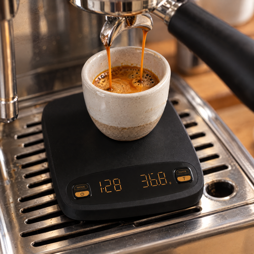 Weighing a double espresso on the scale with the timer running